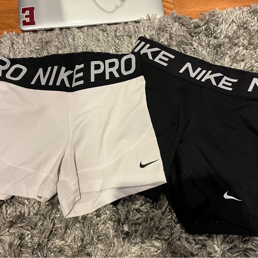 Two pairs of Nike Pros BLACK AND WHITE size SMALL
